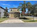 Charming home with a two-car garage, brick-paved driveway, and landscaped front yard at 11796 Crestridge Loop, New Port Richey, FL 34655