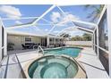Screened-in pool and spa with a large patio for outdoor lounging and entertaining at 1216 Yawl Way, Venice, FL 34285