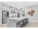 Bright kitchen with a large island, stainless steel appliances, and pendant lighting at 12617 Wetmore Ct, Odessa, FL 33556