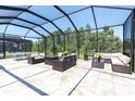 Screened-in patio with comfortable seating, perfect for outdoor entertaining at 12617 Wetmore Ct, Odessa, FL 33556