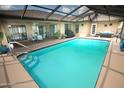 A sparkling screened-in pool featuring a covered patio and plenty of room for entertaining at 13100 Fish Cove Dr, Spring Hill, FL 34609