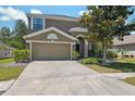 Charming two-story home with a well-manicured lawn, mature landscaping, and a two-car garage at 18331 Waydale Loop, Hudson, FL 34667