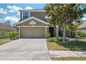 Charming two-story home with a well-manicured lawn, mature landscaping, and a two-car garage at 18331 Waydale Loop, Hudson, FL 34667