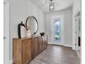 Inviting entryway with tile flooring, a decorative table, and a glass-paneled front door at 2431 Murray Pass, Odessa, FL 33556