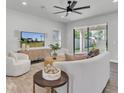 Cozy living room with neutral tones, modern furniture, and a view of the backyard at 2431 Murray Pass, Odessa, FL 33556
