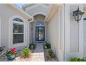 Inviting front entrance with a decorative glass door and landscaped walkway at 312 Barrington Ct, Spring Hill, FL 34609
