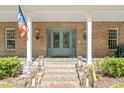 Elegant entrance with double doors, sidelights, stone steps, and brick columns at 3431 Saturn Rd, Brooksville, FL 34604