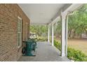 Relaxing covered porch area featuring a swing, perfect for enjoying the outdoors at 3431 Saturn Rd, Brooksville, FL 34604