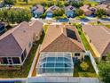 Aerial view of home with screened-in pool and solar panels on the roof at 4321 High Ridge Ave, Spring Hill, FL 34609