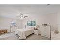 Cozy bedroom with neutral decor, soft carpet, and plenty of natural light at 4504 Dewey Dr, New Port Richey, FL 34652