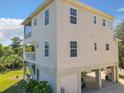 Lovely coastal home on stilts offers a screened porch, multiple windows, and outdoor access at 4514 Fishman Ave, Weeki Wachee, FL 34607