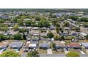 An aerial view of the neighborhood showcasing the single-story home among mature trees at 4607 Kennedy Dr, New Port Richey, FL 34652