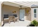 Inviting front porch area, decorated with sunflowers and a ceiling fan at 4856 Alamo Ct # 4856, New Port Richey, FL 34655