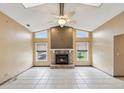 Cozy living room features a stone fireplace, vaulted ceilings, and tiled floors for a comfortable and inviting atmosphere at 5411 Joyner Ave, Spring Hill, FL 34608