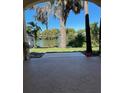 A view of the lake from the backyard featuring an extended concrete patio at 5736 Colonial Dr, New Port Richey, FL 34653