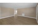 Spacious living room featuring wood floors and open access to the kitchen at 6206 11Th Ave, New Port Richey, FL 34653