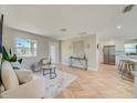 Open-concept living room and kitchen with bar stool seating at the island at 6432 Boatyard Dr, Hudson, FL 34667