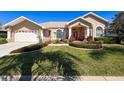Beautiful single-story home with well-manicured lawn and a two-car garage at 8523 Regal Ln, Hudson, FL 34667