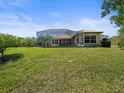 Expansive backyard with a screened-in pool enclosure, offering a perfect blend of privacy and outdoor enjoyment at 9159 Trevino Dr, Weeki Wachee, FL 34613