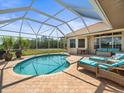 Inviting screened-in pool area featuring lounge chairs and beautiful views, perfect for relaxation and entertainment at 9159 Trevino Dr, Weeki Wachee, FL 34613