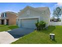This house features a two-car garage, an expansive driveway, and an ample lawn at 951 Nodding Shade Dr, Brooksville, FL 34604
