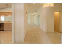 Bright hallway featuring tile floors and neutral paint, leading to other rooms at 1013 Sweet Jasmine Dr, Trinity, FL 34655