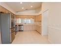 The kitchen features stainless appliances, and ample cabinet and counter space at 1013 Sweet Jasmine Dr, Trinity, FL 34655