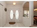 Bright entryway featuring tiled floors, double front doors, and a transom window at 1034 Aladdin Rd, Spring Hill, FL 34609