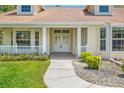 A close-up view of the front entrance with a decorative door and landscaped surroundings at 10540 Noddy Tern Rd, Weeki Wachee, FL 34613