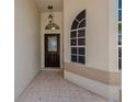 View of the front entryway showing a tiled floor, door, and transom at 1171 Dartford Dr, Tarpon Springs, FL 34688