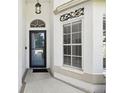 This front entrance showcases a glass-paneled door, decorative wall art, and classic design elements at 11732 Wheatfield Loop, Hudson, FL 34667
