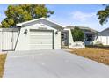 Close-up of an attached garage and landscaped features of the home's exterior at 12065 Shadow Ridge Blvd, Hudson, FL 34669