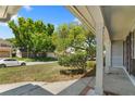 Inviting front porch with classic columns and views of a lush, green yard at 12204 Pepper Mill Dr, Hudson, FL 34667