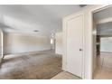 Spacious living room featuring neutral carpet, fresh paint, and an open layout at 12204 Pepper Mill Dr, Hudson, FL 34667