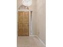 Welcoming entryway with light-toned floor tiles and featuring a wooden front door with decorative lighting at 1260 Dartford Dr, Tarpon Springs, FL 34688