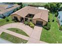 An elevated view showcases the home's unique layout, circular driveway, and mature landscaping at 13111 Sheridan Dr, Hudson, FL 34667
