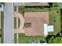 Bird's-eye view of a home, revealing the roof design, driveway, and surrounding neighborhood at 13111 Sheridan Dr, Hudson, FL 34667