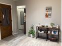 Inviting foyer with wood-look floors, front door, console, and decorative accents at 13111 Sheridan Dr, Hudson, FL 34667