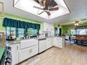 Bright kitchen featuring modern appliances, granite countertops, and a stylish farmhouse sink at 13111 Sheridan Dr, Hudson, FL 34667