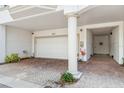 Attached garage with brick-paved driveway and adjacent walkway to a doorway at 1340 Bayshore Blvd # 411, Dunedin, FL 34698