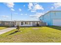 Charming single-story home features a well-maintained lawn, mature tree, and a cozy, inviting facade at 13632 Britton Dr, Hudson, FL 34667