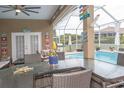 View of the pool and lanai with patio furniture and outdoor kitchen at 13942 Talmage Loop, Hudson, FL 34667