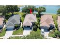 An aerial view of the house showcasing its proximity to a tranquil lake and beautifully landscaped surroundings at 15038 Tamarind Loop, Spring Hill, FL 34609
