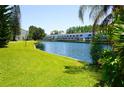 Waterfront view of complex, including blue canal and grassy landscape at 1881 Mazo Mnr # I-6, Lutz, FL 33558