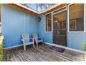 Cozy front porch features outdoor seating, perfect for relaxing and enjoying the outdoors at 1916 & 1910 Beachway Ln, Odessa, FL 33556