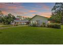 Lush front lawn and landscaping surrounding the charming single-story home at 2400 Commack Ct, New Port Richey, FL 34655