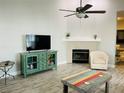 Spacious living room with vaulted ceilings, fan, fireplace, and decorative furniture at 2729 Penzance St, Palm Harbor, FL 34684