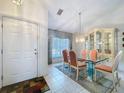 Formal dining area with glass table, decorative china cabinet, and lots of natural light at 3054 Oakbrook Cir, Clearwater, FL 33759