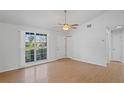 Inviting living room with new flooring, neutral walls, and natural light from a large front window at 3141 Loomis Dr, New Port Richey, FL 34655