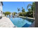 Sparkling backyard pool with lounge seating, and lush landscaping, creating a tranquil oasis at 3555 Bracknell Ct, Land O Lakes, FL 34638